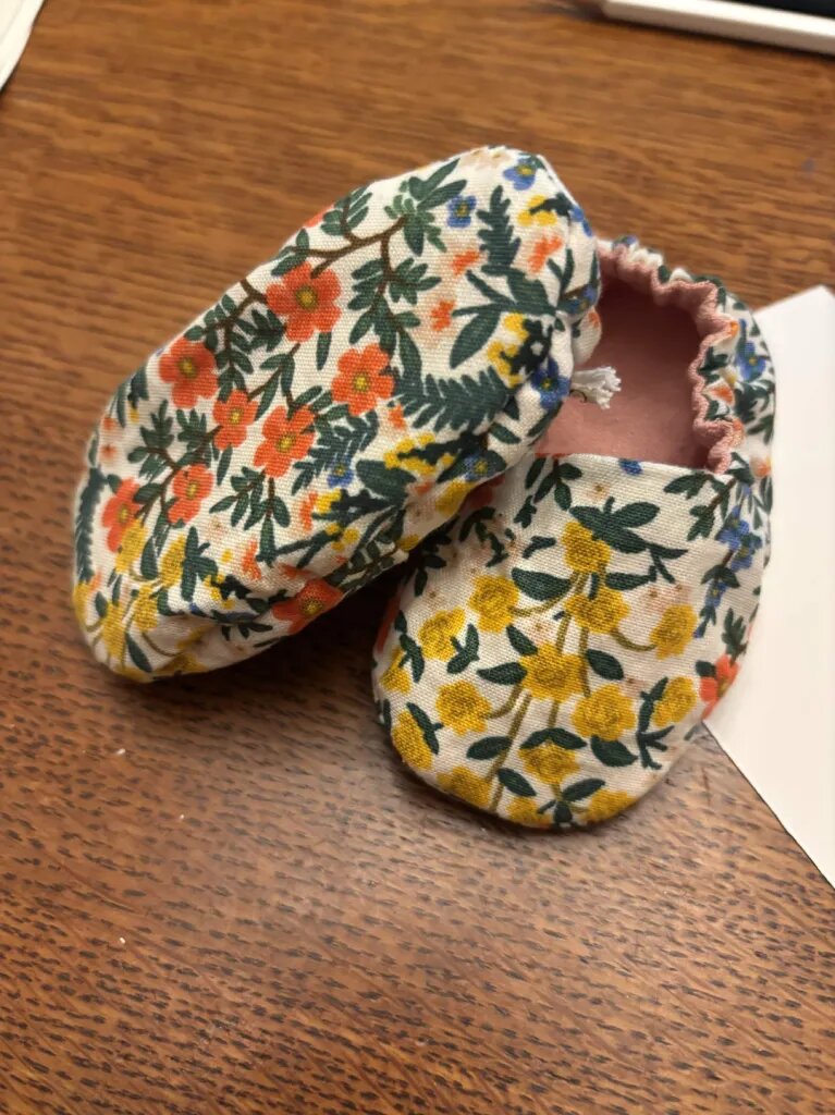 Pro-Life Baby Slippers in a cream wildflower print with pink linen lining